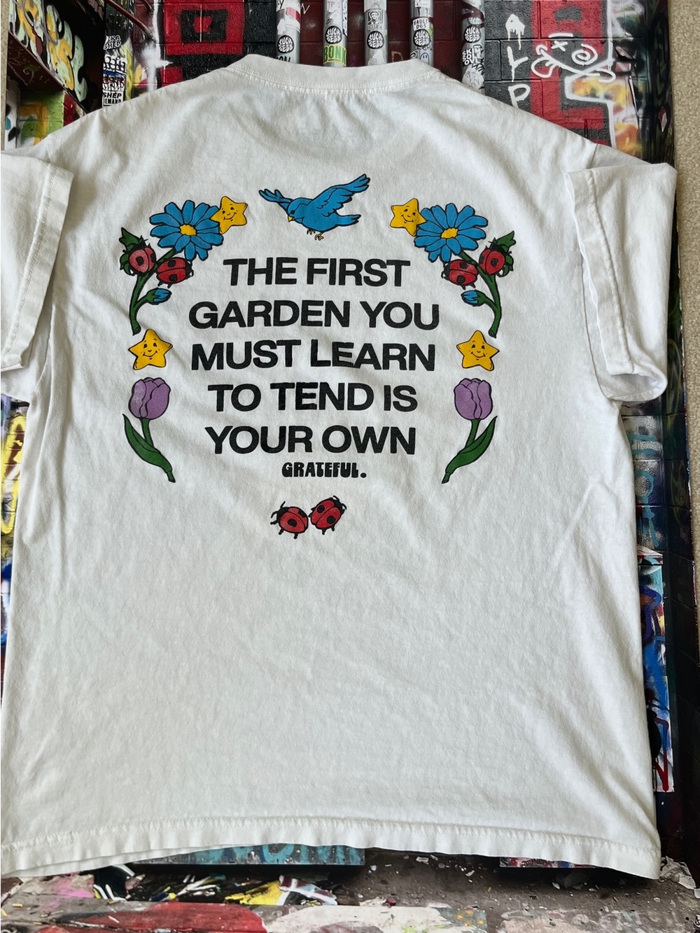 GRATEFUL White Graphic Tee - "The First Garden"